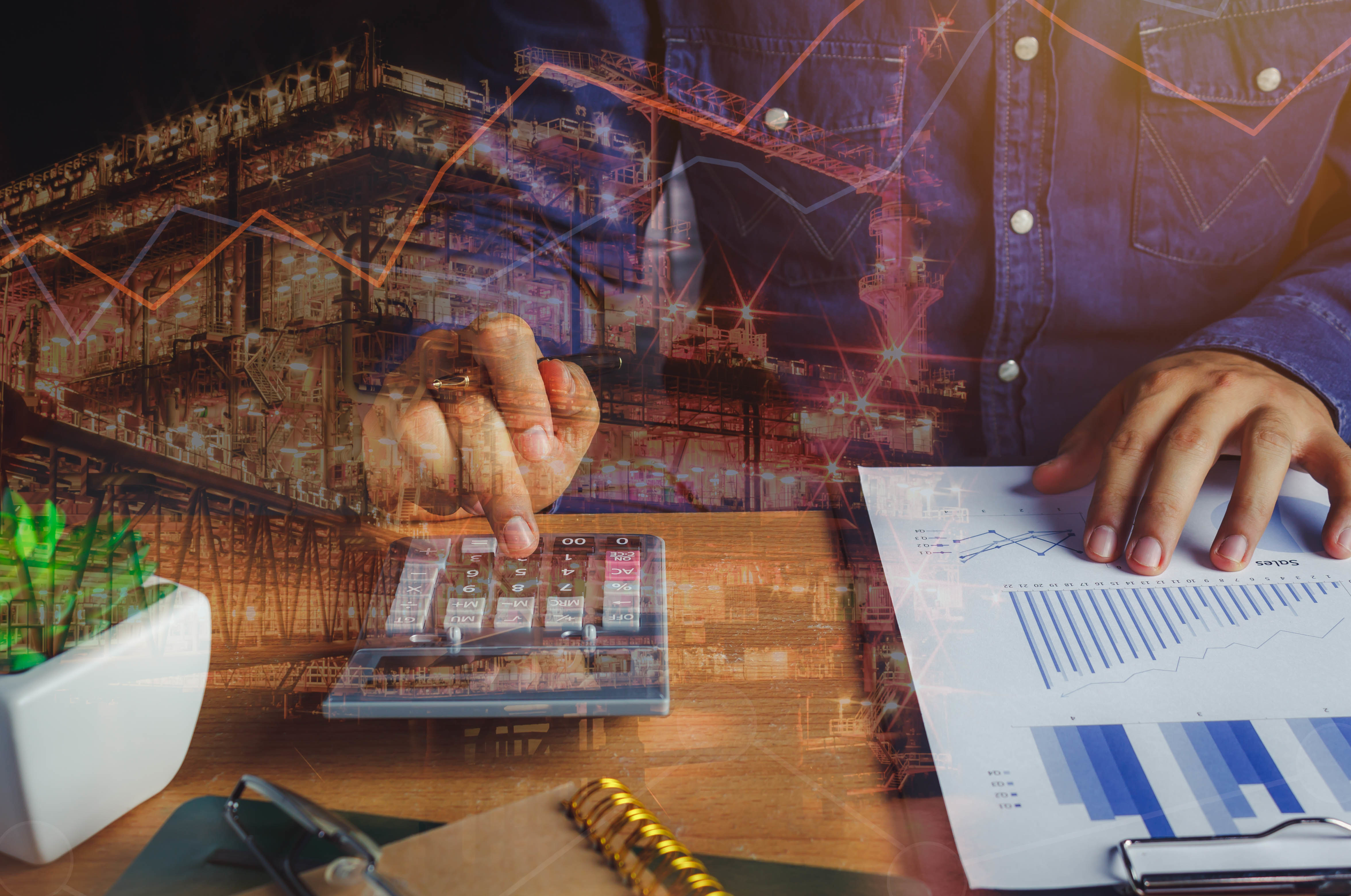close up asian man calculate banking finance or saving economy background.Double exposure industrial offshore oil and gas platform for cost and growth up business on table office desk with accessories close up asian man calculate banking finance or saving economy background.Double exposure industrial offshore oil and gas platform for cost and growth up business on table office desk with accessories